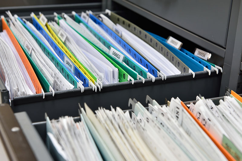 Photo of filing cabinet with papers